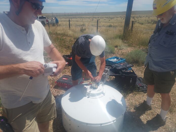 People working on microwave dish